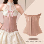 A dusty rose structured waist trainer corset shown on a model wearing a cream lace halter dress, alongside a flat product view of the corset. The text 'Dusty Rose/ダスティローズ' is visible at the bottom right.