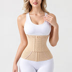A beige waist trainer belt worn by a model, shown from the chest down in a studio setting with a white background.