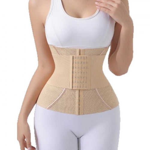 A beige waist trainer belt worn by a model, shown from the chest down in a studio setting with a white background.