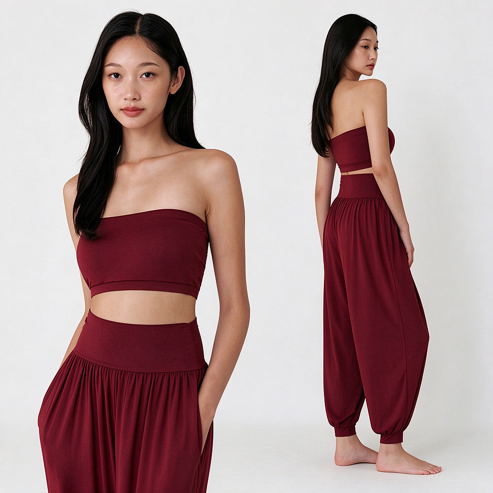 A model is shown in a studio setting wearing a two-piece maroon set consisting of a strapless crop top and matching high-waisted harem pants. The image features two views: a close-up front view on the left and a full-body rear view on the right, against a clean white background.